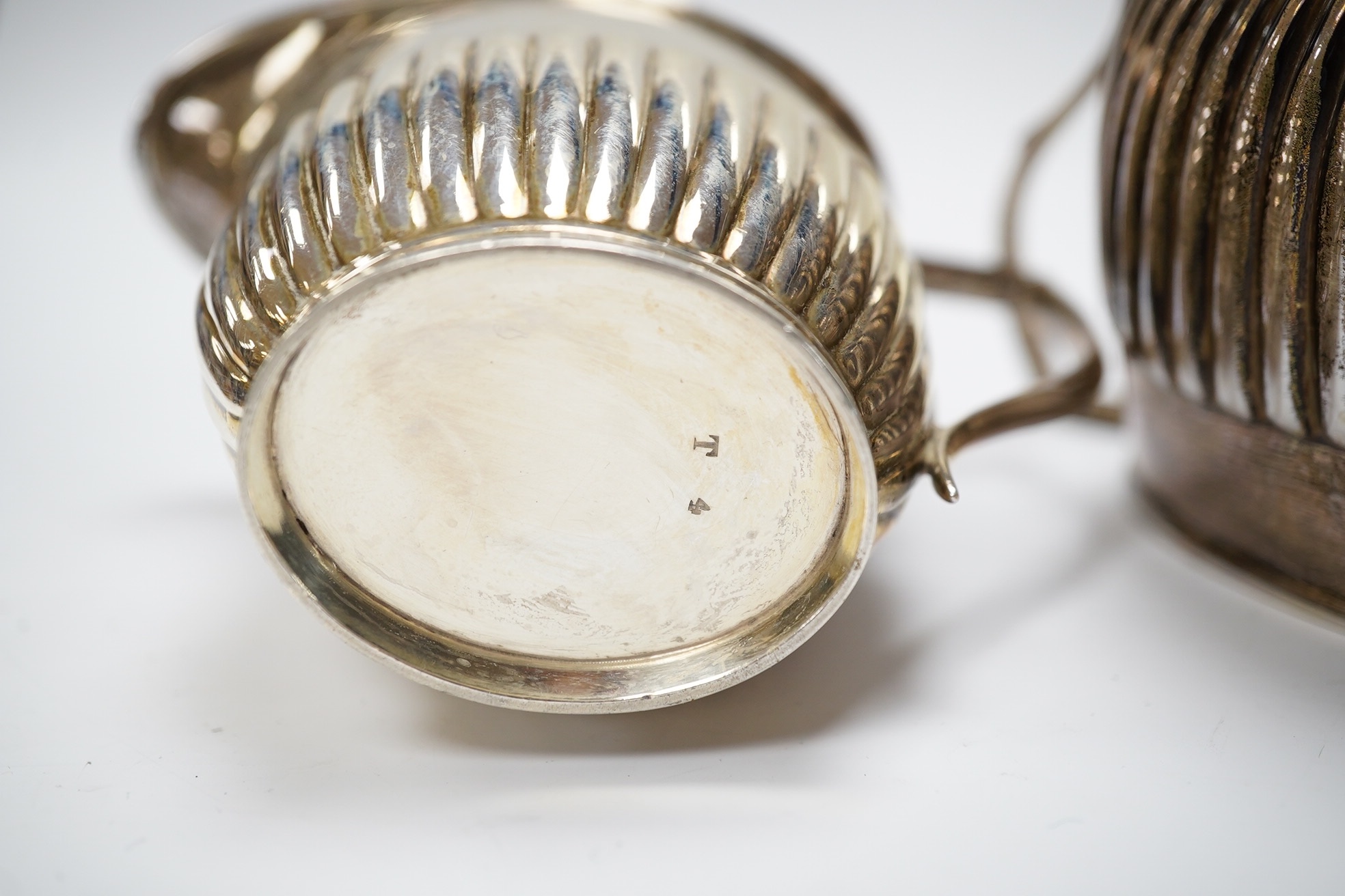 An Edwardian silver half fluted cream jug and two handled sugar bowl, by William Hutton & Sons, London, 1906/7, 11.9oz. Condition - fair